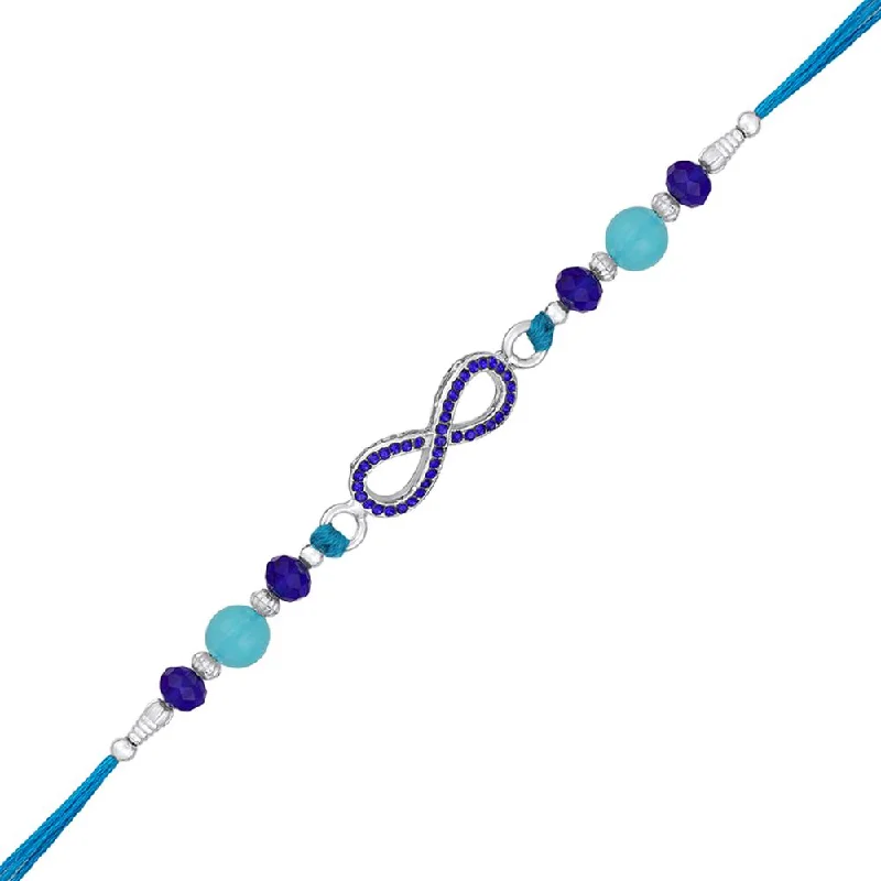 Affordable Glamour – Premium Jewelry For Less Mahi Rhodium Plated Infinity Shape Rakhi with Blue Crystals for Bhaiya, Brother, Bhai, Bro (RA1100780RBlu)